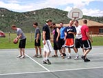 A group of young men line up for free throw practice at the Sports Court.