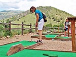 A woman prepares to putt.  Putting is the name of the game at the Prairie Dog Greens mini-golf course.