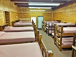 An inside of view of the other Dorm in the Bunkhouse, bunk beds line the walls.