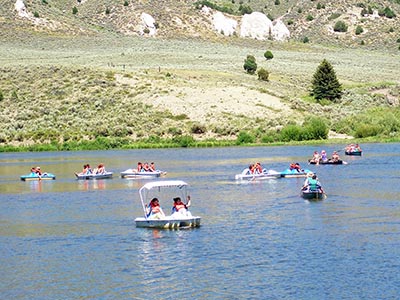 Paddle boats and canoes navigate Reid Ranch's lake.
