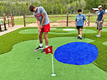 Having already avoided the faux water trap this young man has an easy putt.