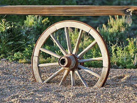 A wagon wheel sits as a decorative piece as part of Reid Ranch's western-style theme.