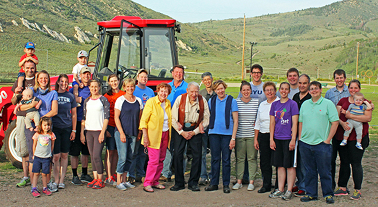 The Reid Family pose in front of a tractor.