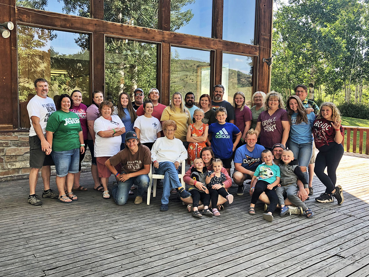 A family stands out on the deck of the Red Creek lodge for their picture.