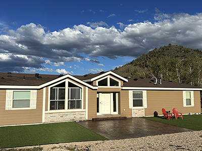 Front exterior of the Aspen Ridge Villa at Reid Ranch slightly angled with chairs out front.