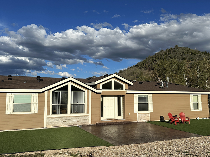 Front exterior of the Aspen Ridge Villa at Reid Ranch slightly angled with chairs out front.